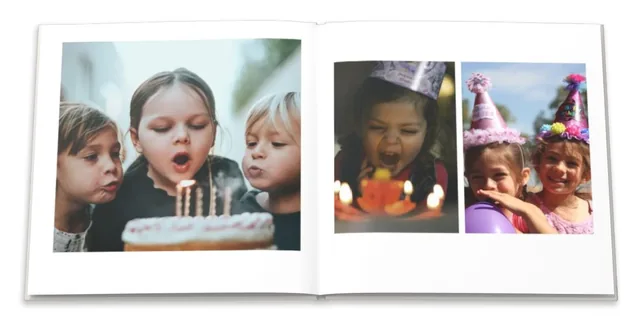 An open photo book: children blowing out birthday candles