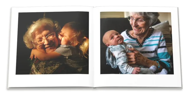 An open photo book: a grandmother hugging her granddaughter, and holding a baby
